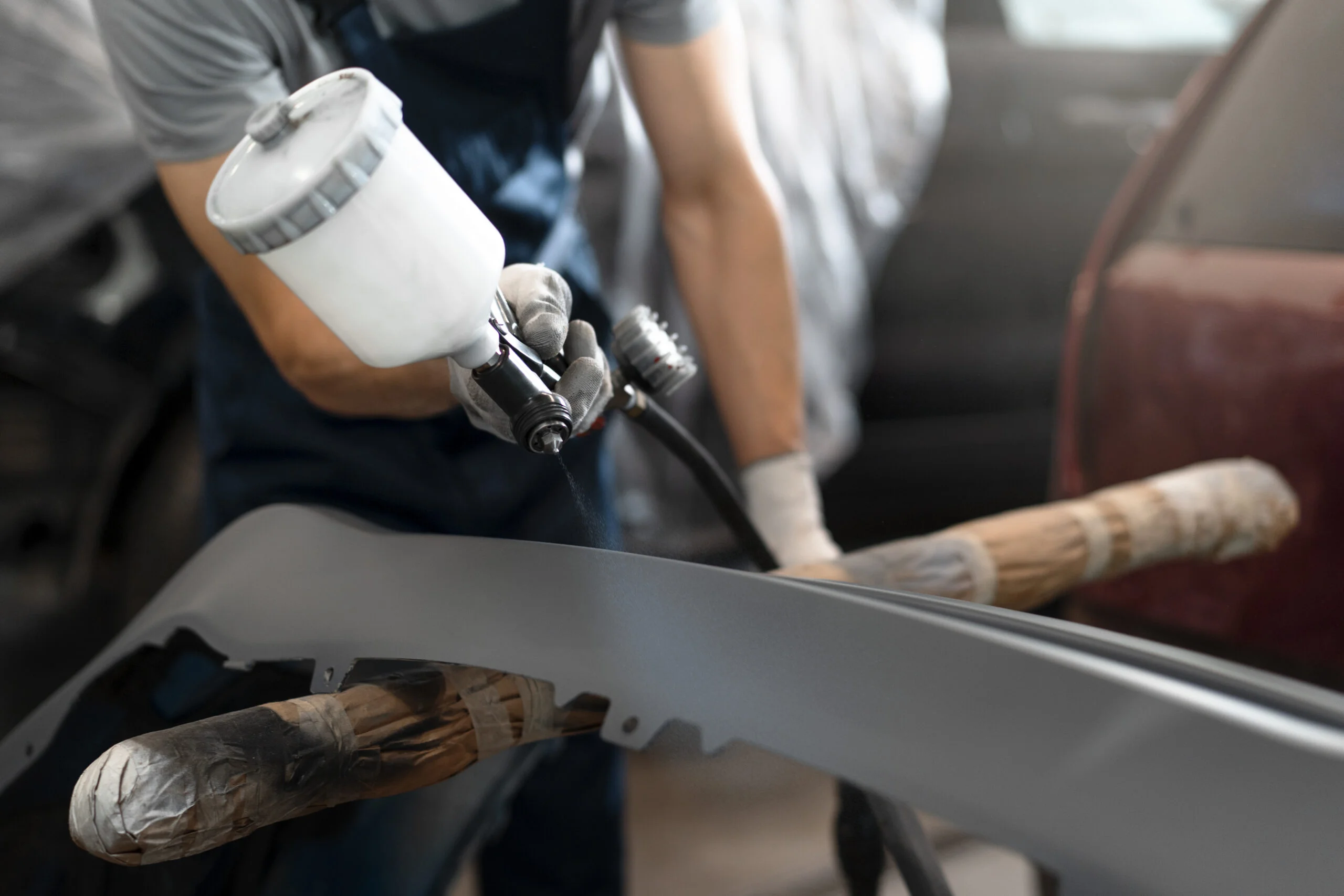 male-painter-overalls-doing-his-work-car-shop